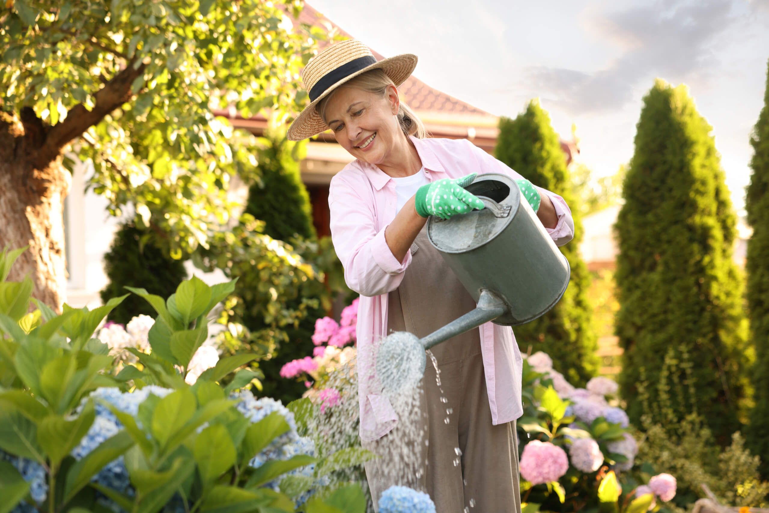 Lady watering flowers with watering can