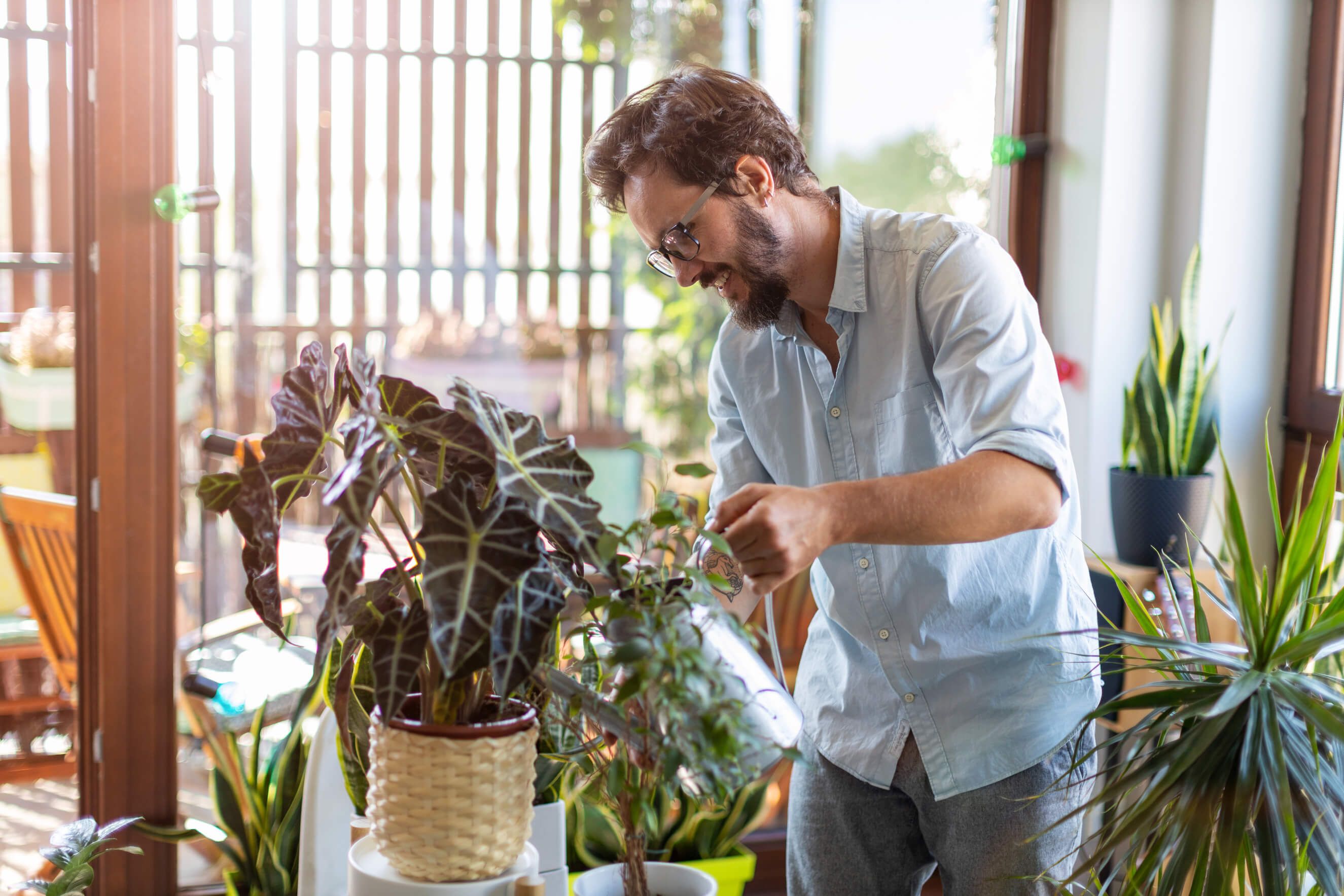 Man watering flowers with watering can